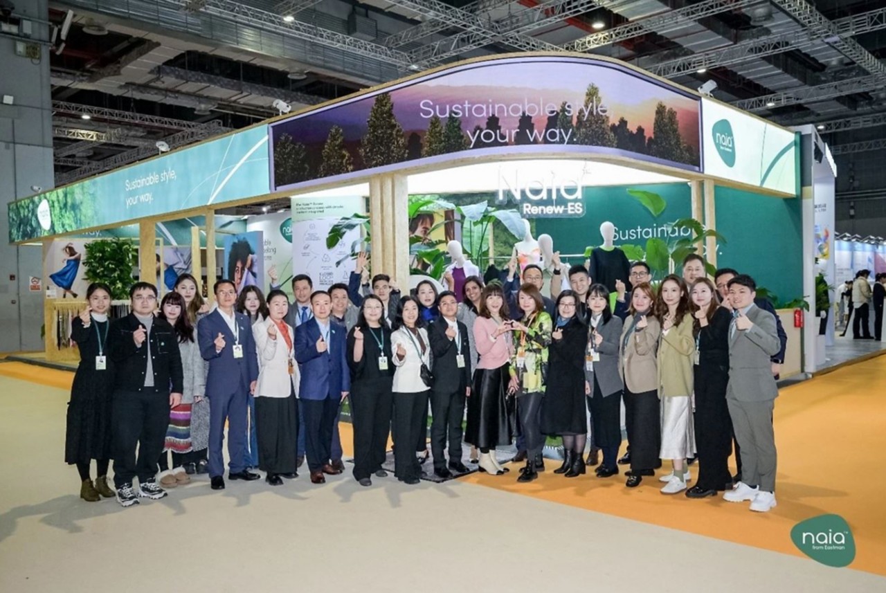 Group of 29 Eastman textiles team members at the Naia booth 
