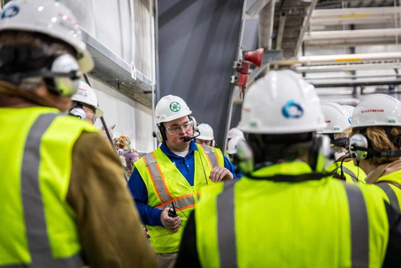 Spencer Tidwell in proper protection equipment, leading a tour of Eastman’s methanolysis plant.  